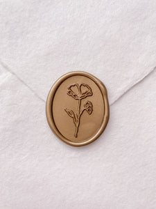 Oval flower wax seal in gold on handmade paper envelope
