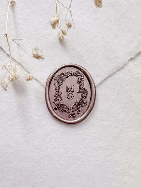 Light bronze custom monogram wax seal featuring a Baroque style vintage crest design