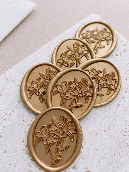 Oval lily floral wax seals in light gold color_front angle