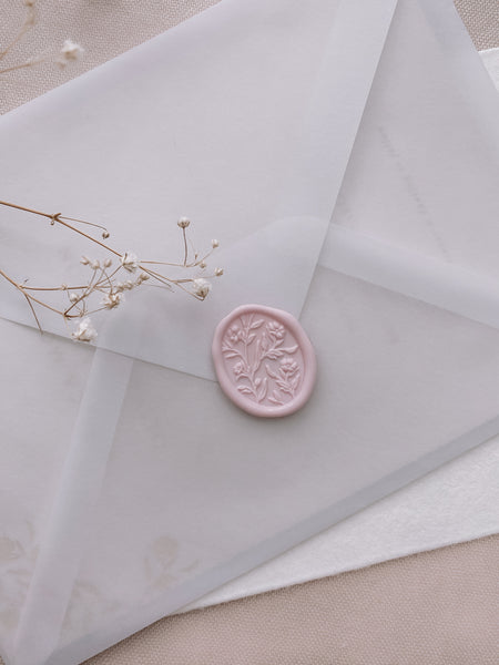 Oval floral pattern wax seal in pale blush on vellum envelope