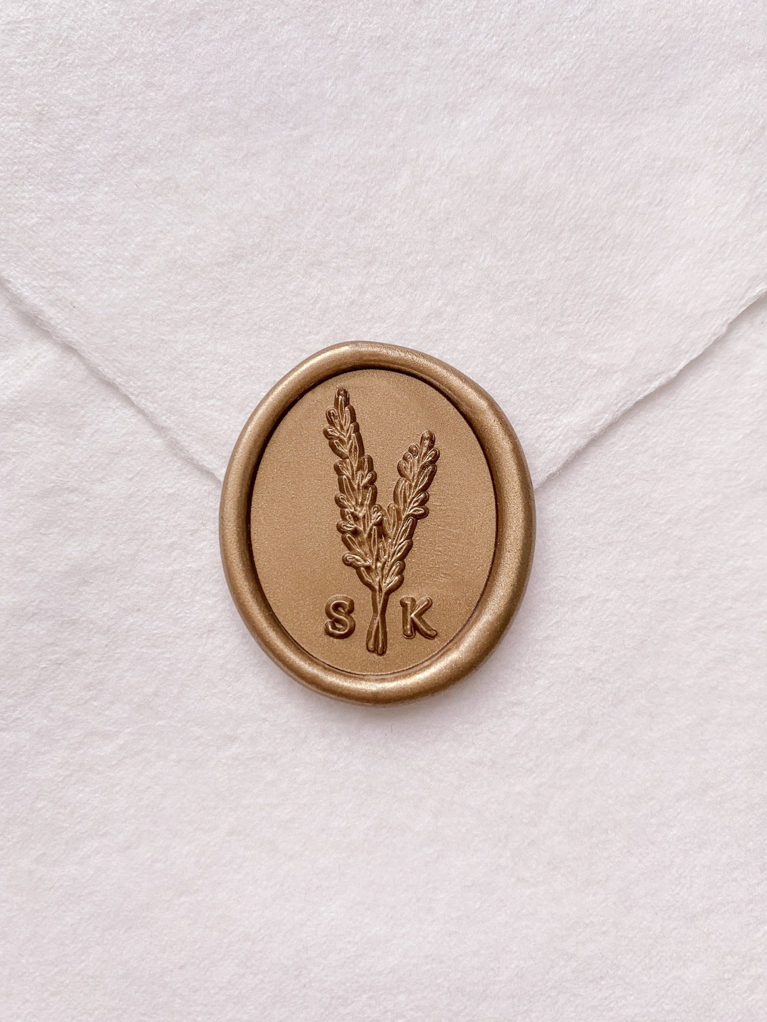 Rosemary leaf monogram gold custom wax seal on beige handmade paper envelope