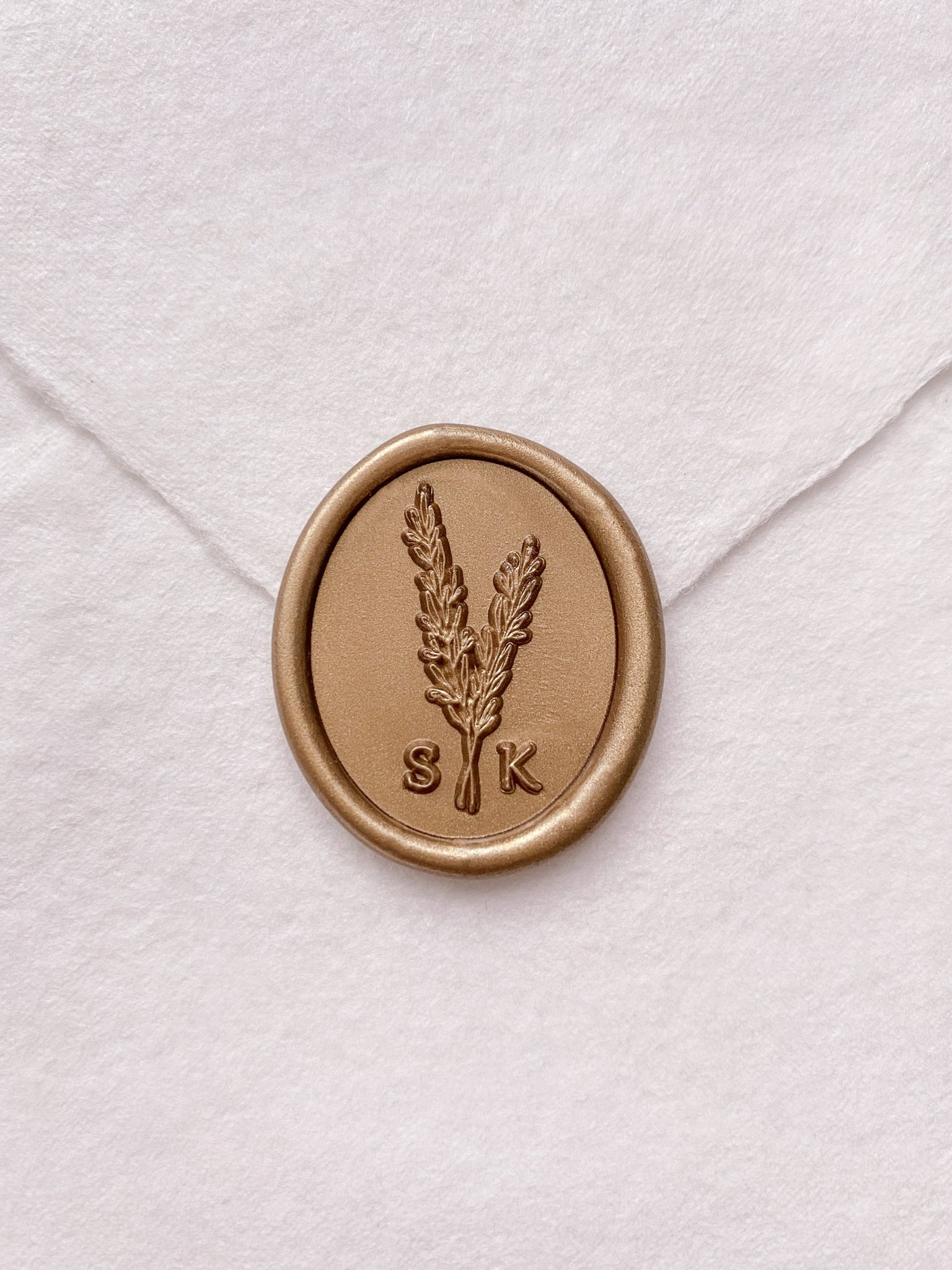 Rosemary leaf monogram gold custom wax seal on beige handmade paper envelope