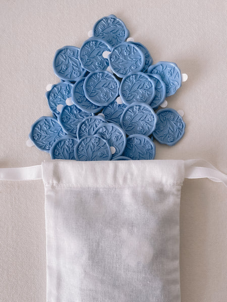 Floral wax seals with 3D engraving in dusty blue with 3M sticker in white linen pouch