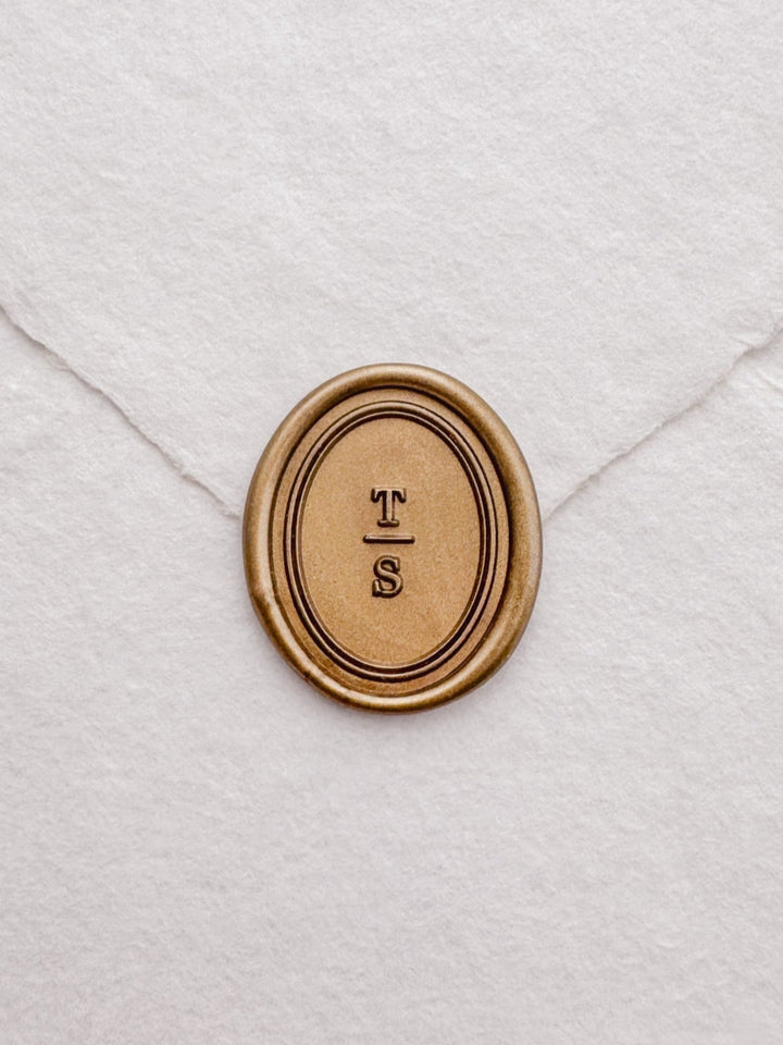 custom initials gold wax seal with an oval double border design 