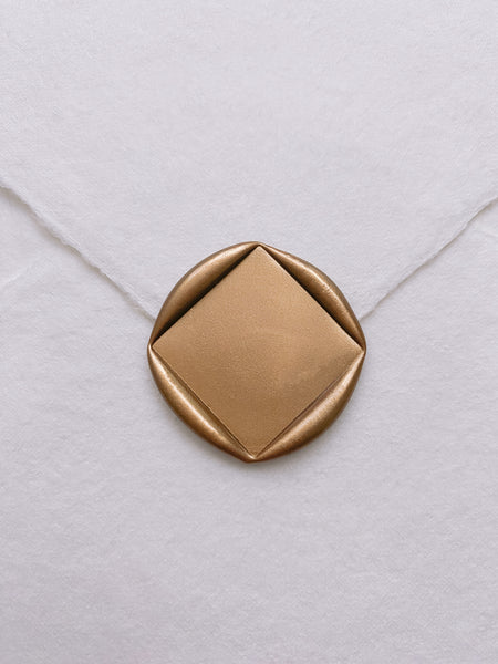 Diamond blank gold wax seal on white handmade paper envelope