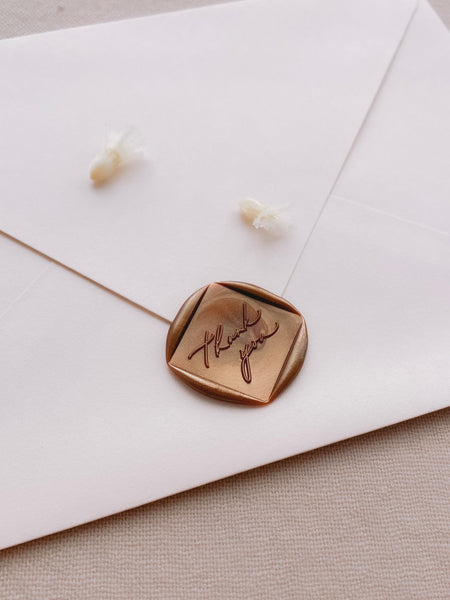 Thank You calligraphy script diamond shaped wax seal in copper on beige envelope 