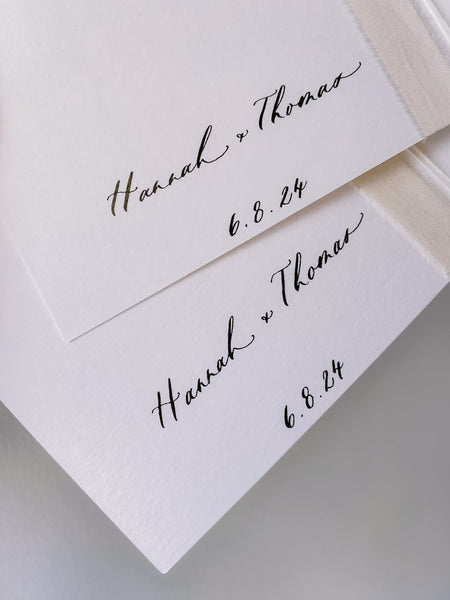 Personalized names in calligraphy on the inner cover of set of white vow books