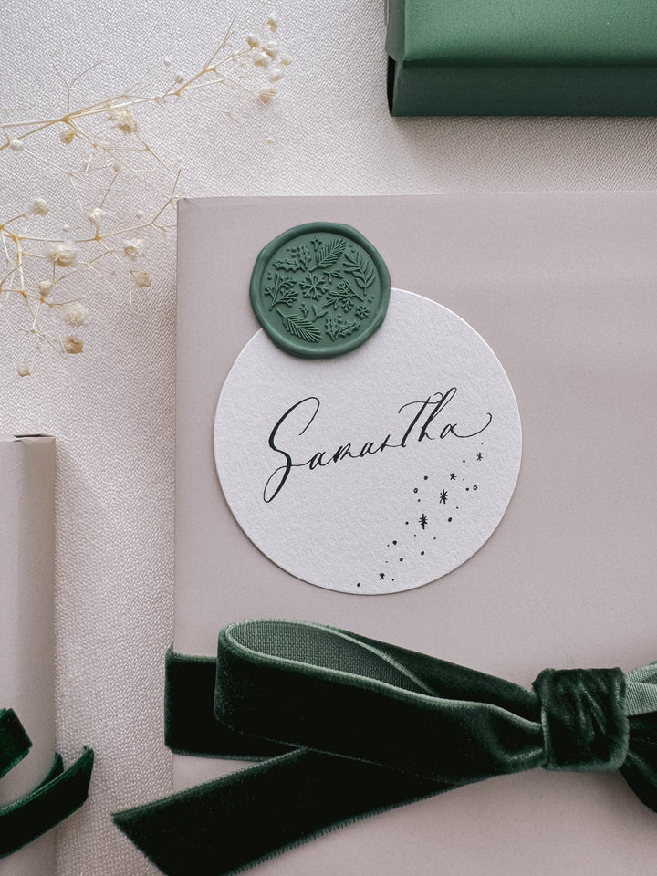 green Christmas wax seal decorated on a festive gift tag
