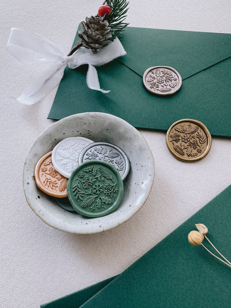 Christmas botanicals and snowflake wax seals and holiday card envelopes