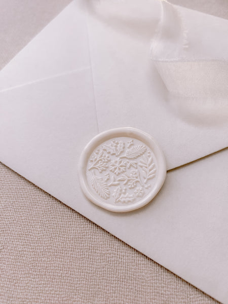 Christmas winter botanical elements wax seal in off-white on white envelope