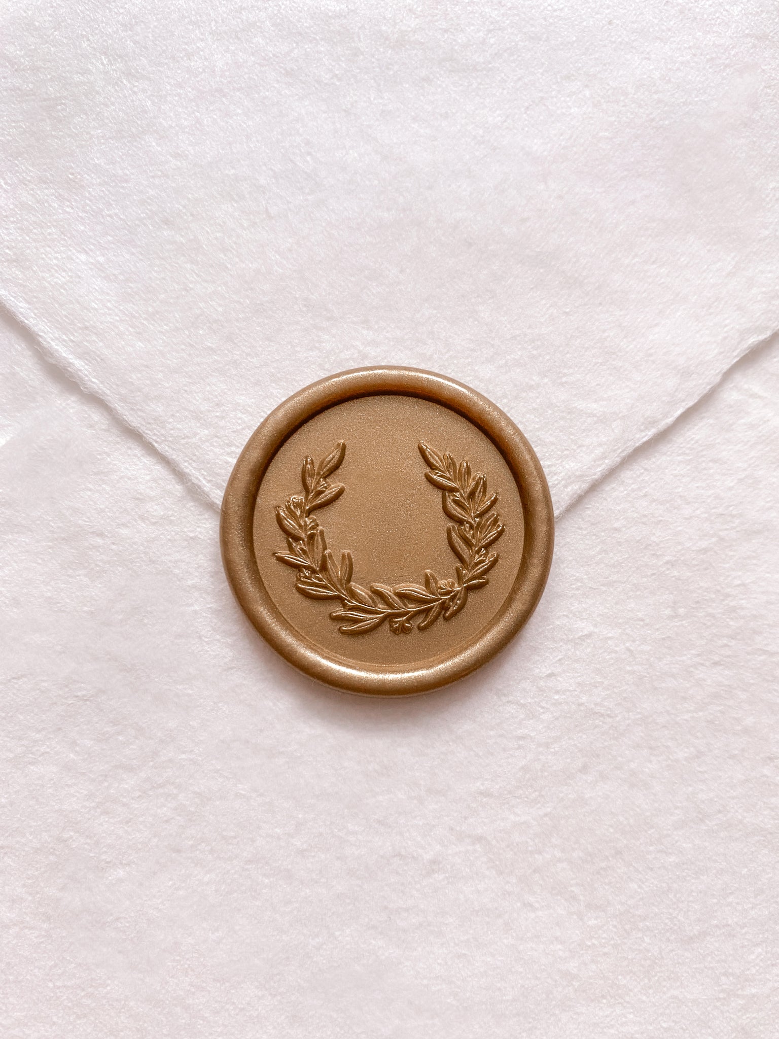 Garden wreath design wax seal in gold on handmade paper envelope