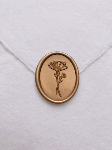 Gold abstract floral oval wax seal on white handmade paper envelope