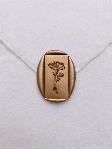 Floral rectangular gold wax seal on beige handmade paper envelope