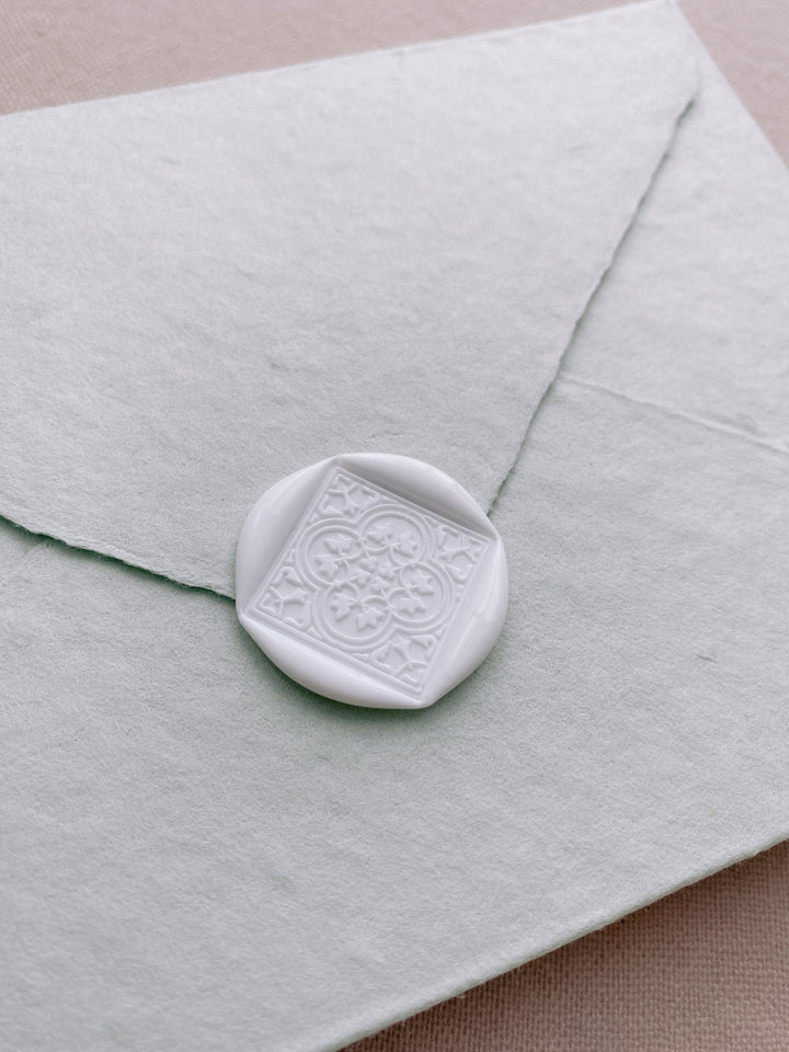 Moroccan tile quatrefoil pattern wax seal in off-white on beige handmade paper envelope