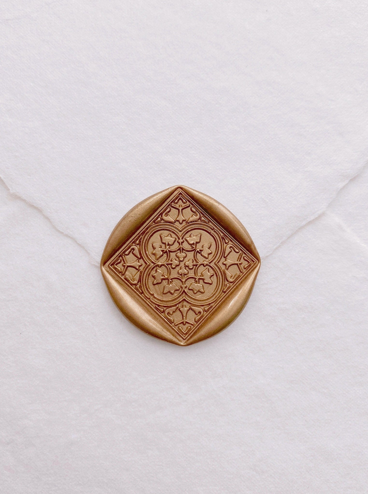 Moroccan tile pattern square shaped wax seal in gold on handmade paper envelope