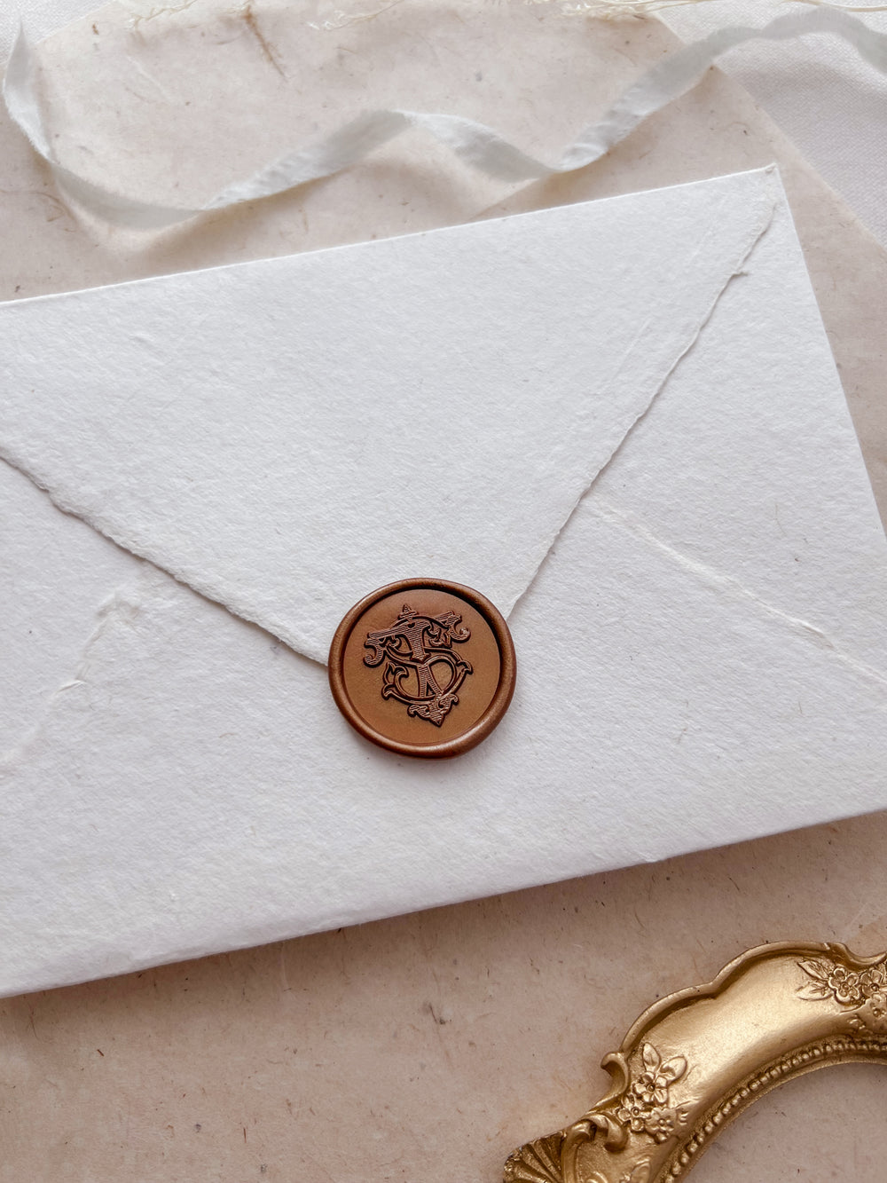 Vintage-style bronze wax sealing stamp with elegant monogram initial design