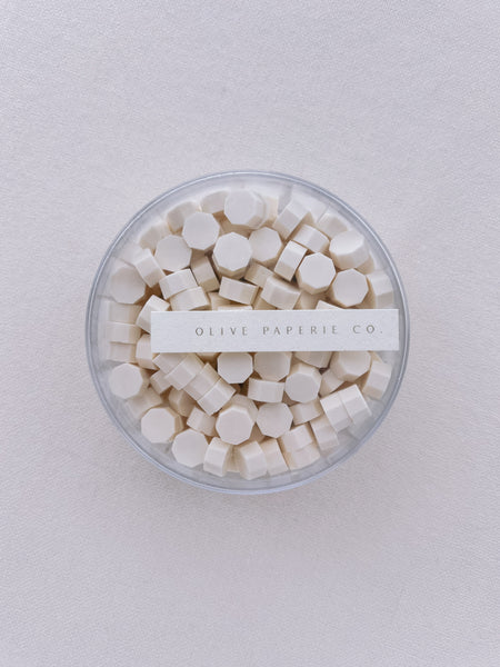 a box of off-white color sealing wax beads