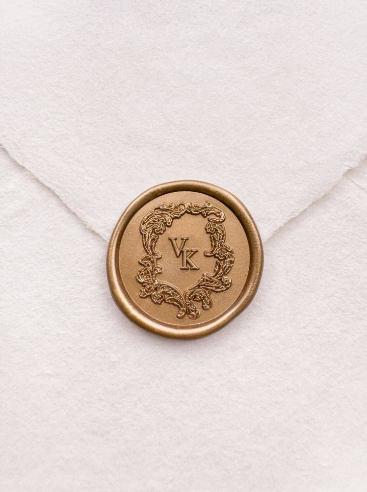 Baroque vintage crest design monogram gold wax seal on a white handmade paper envelope