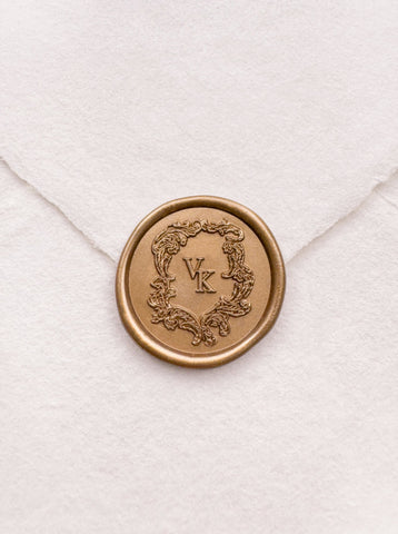 Baroque vintage crest design monogram gold wax seal on a white handmade paper envelope
