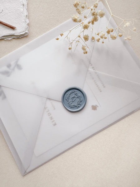 Dusty blue Baroque vintage crest custom initial wax seal on a vellum envelope