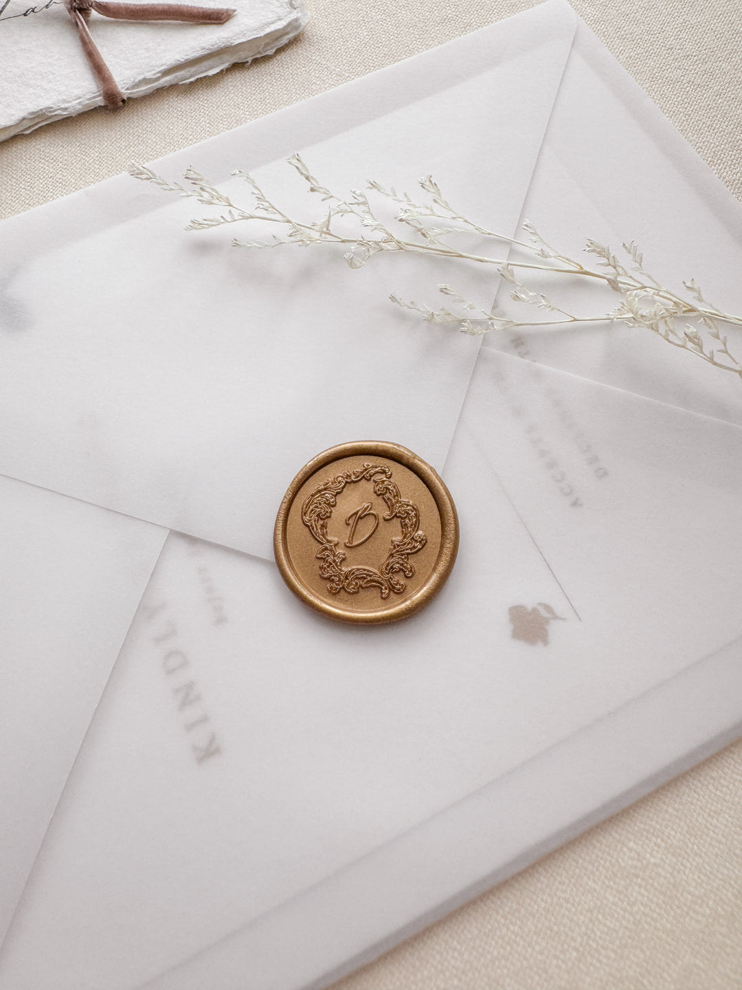 gold vintage frame custom letter wax seal on a vellum wedding invitation envelope