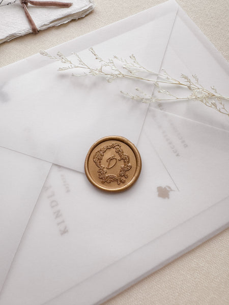 gold vintage frame custom letter wax seal on a vellum wedding invitation envelope