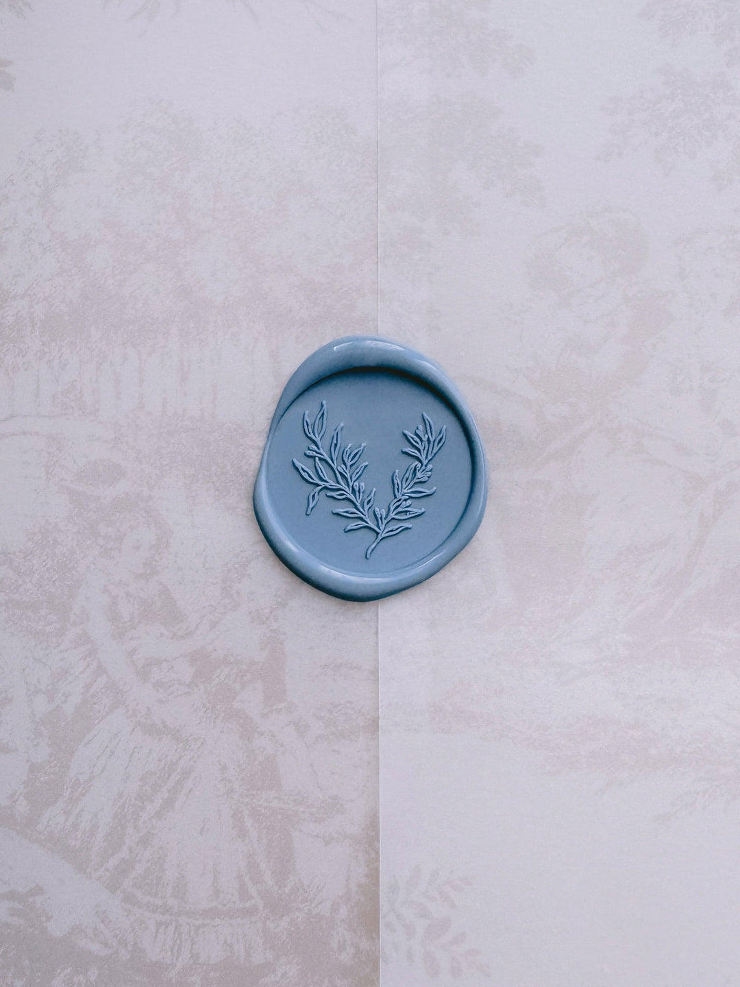 Botanical print dusty blue wax seal on a printed vellum jacket