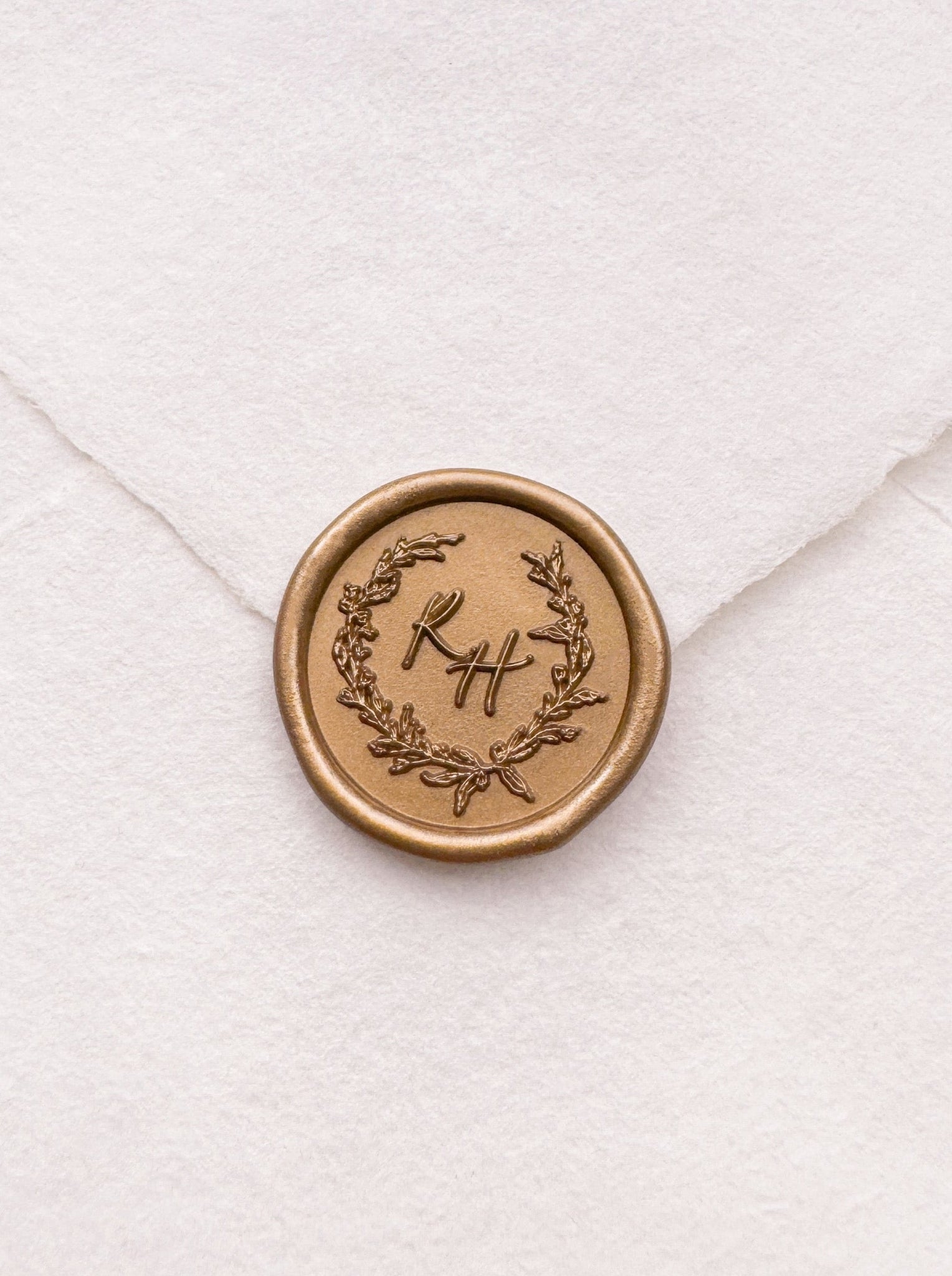 custom initials gold wax seal with a delicate wreath design