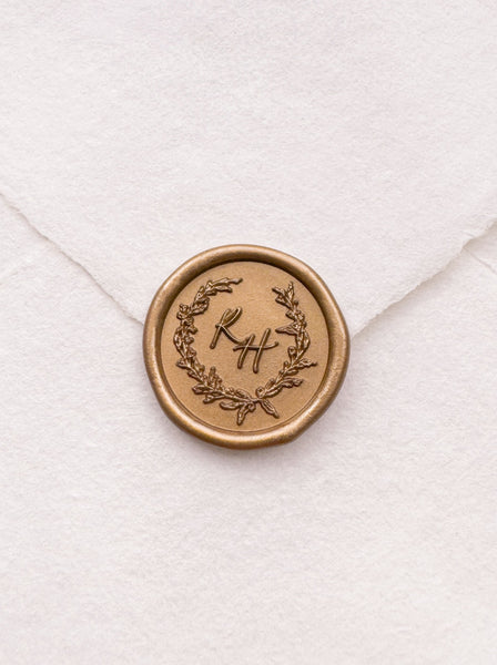 custom initials gold wax seal with a delicate wreath design