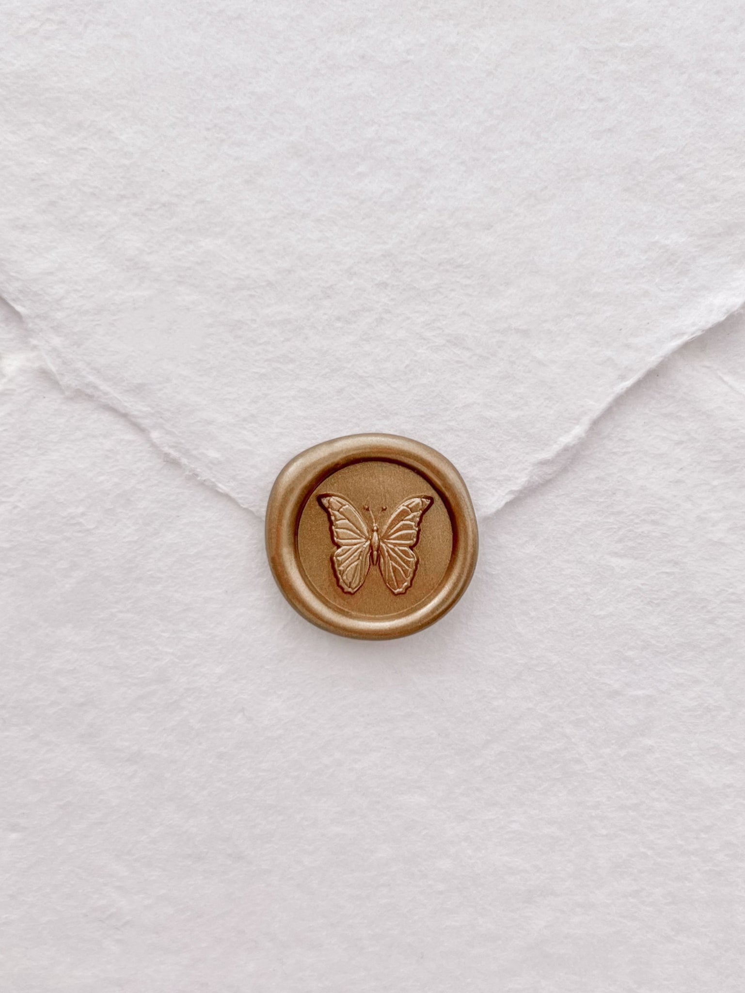 butterfly mini gold wax seal on white handmade paper envelope 