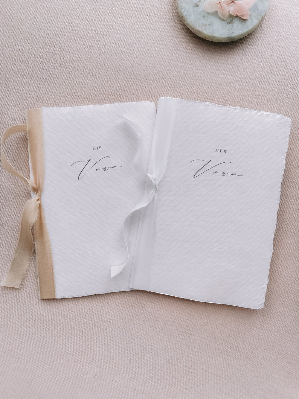 his and her vows white handmade paper vow books tied in white and gold silk ribbons