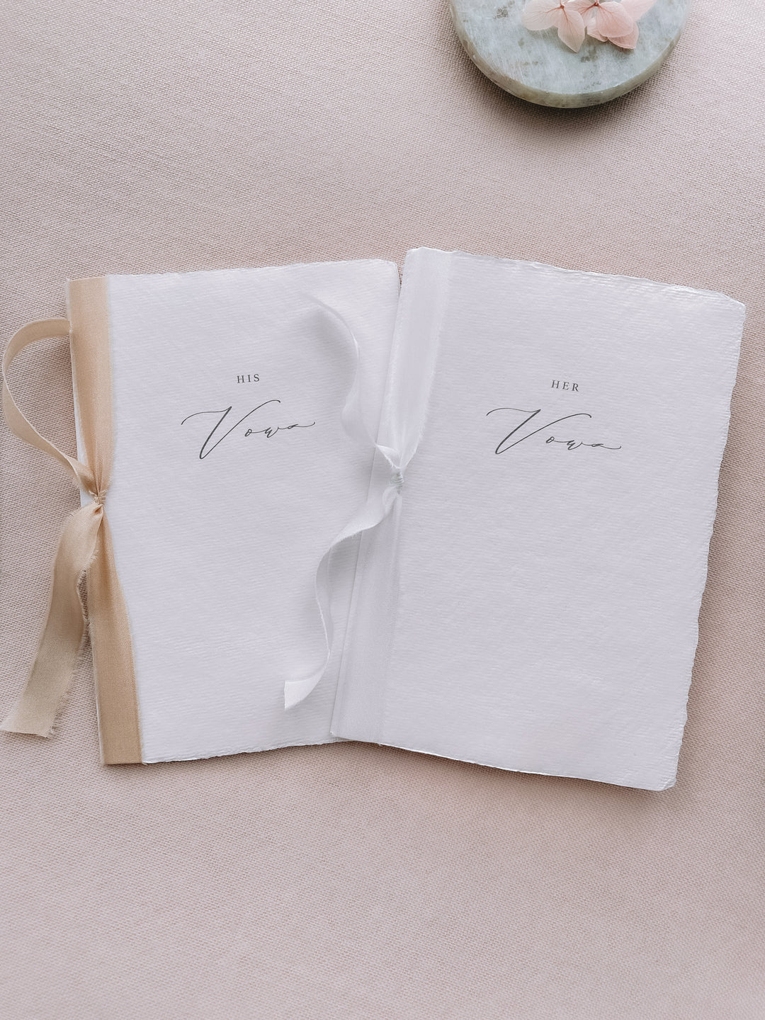 his and her vows white handmade paper vow books tied in white and gold silk ribbons