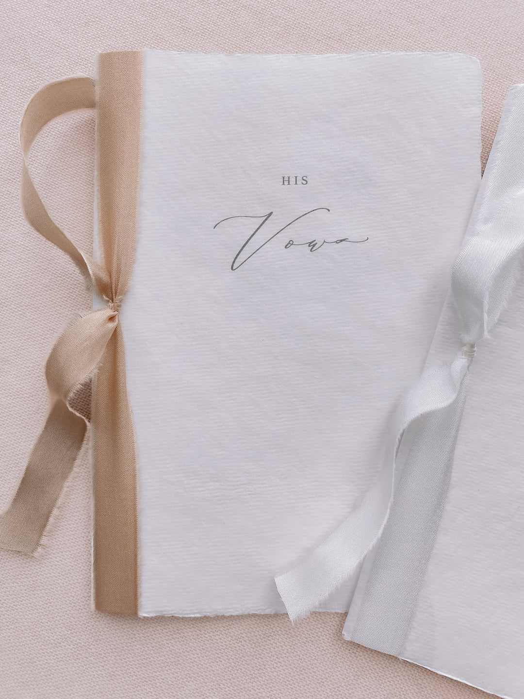 his and her vows white handmade paper vow books tied in white and gold silk ribbons