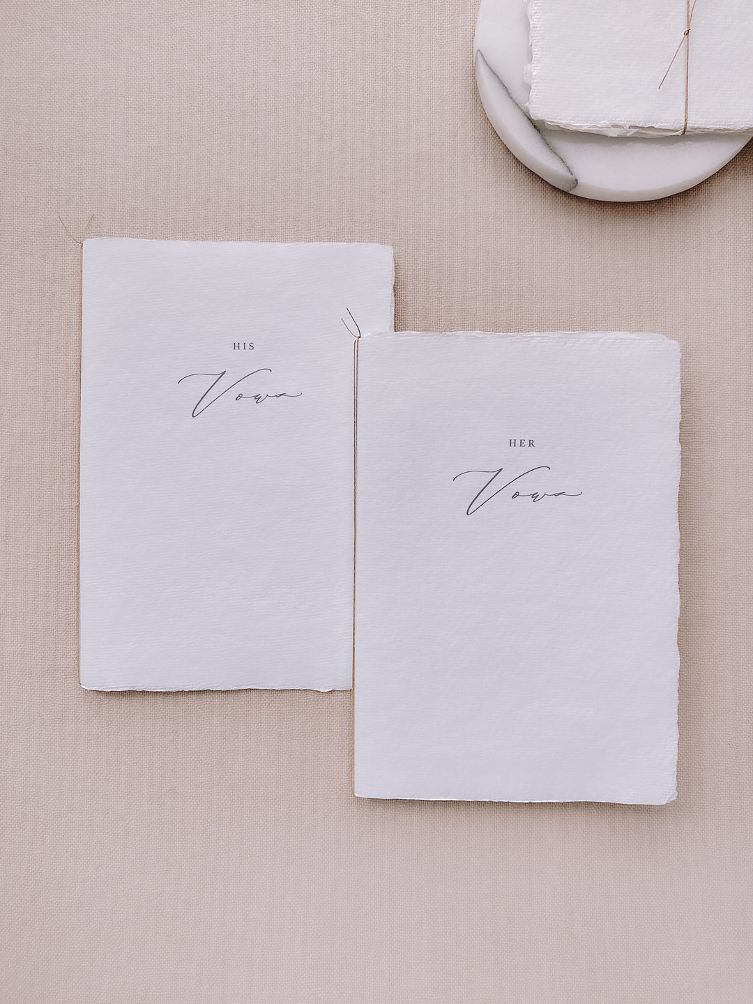 his and her vows white handmade paper vow books tied in brown twine
