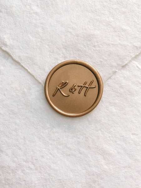 Calligraphy monogram custom wax seal in gold on beige handmade paper envelope