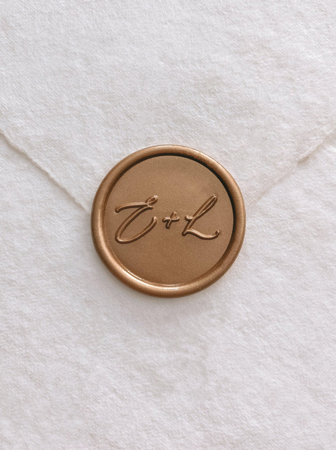 Calligraphy script monogram round gold custom wax seal on beige handmade paper envelope