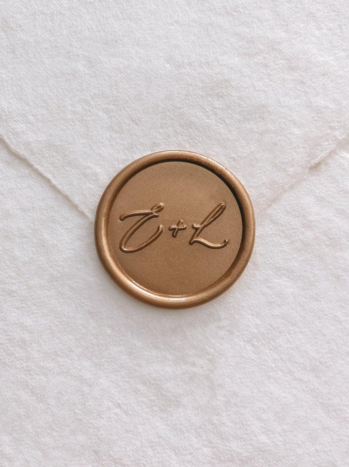 Calligraphy script monogram round gold custom wax seal on beige handmade paper envelope