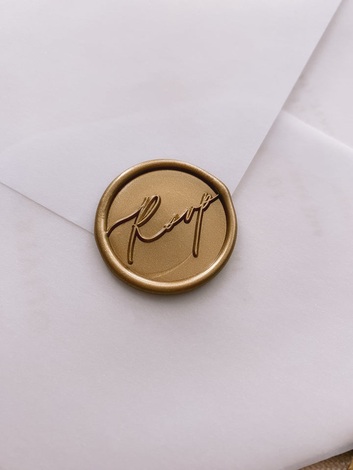 Gold calligraphy script rsvp wax seal on beige paper envelope