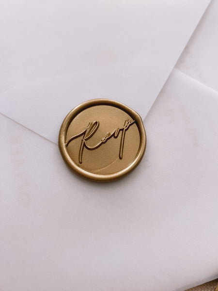 Calligraphy script rsvp wax seal in gold paper envelope_side angle