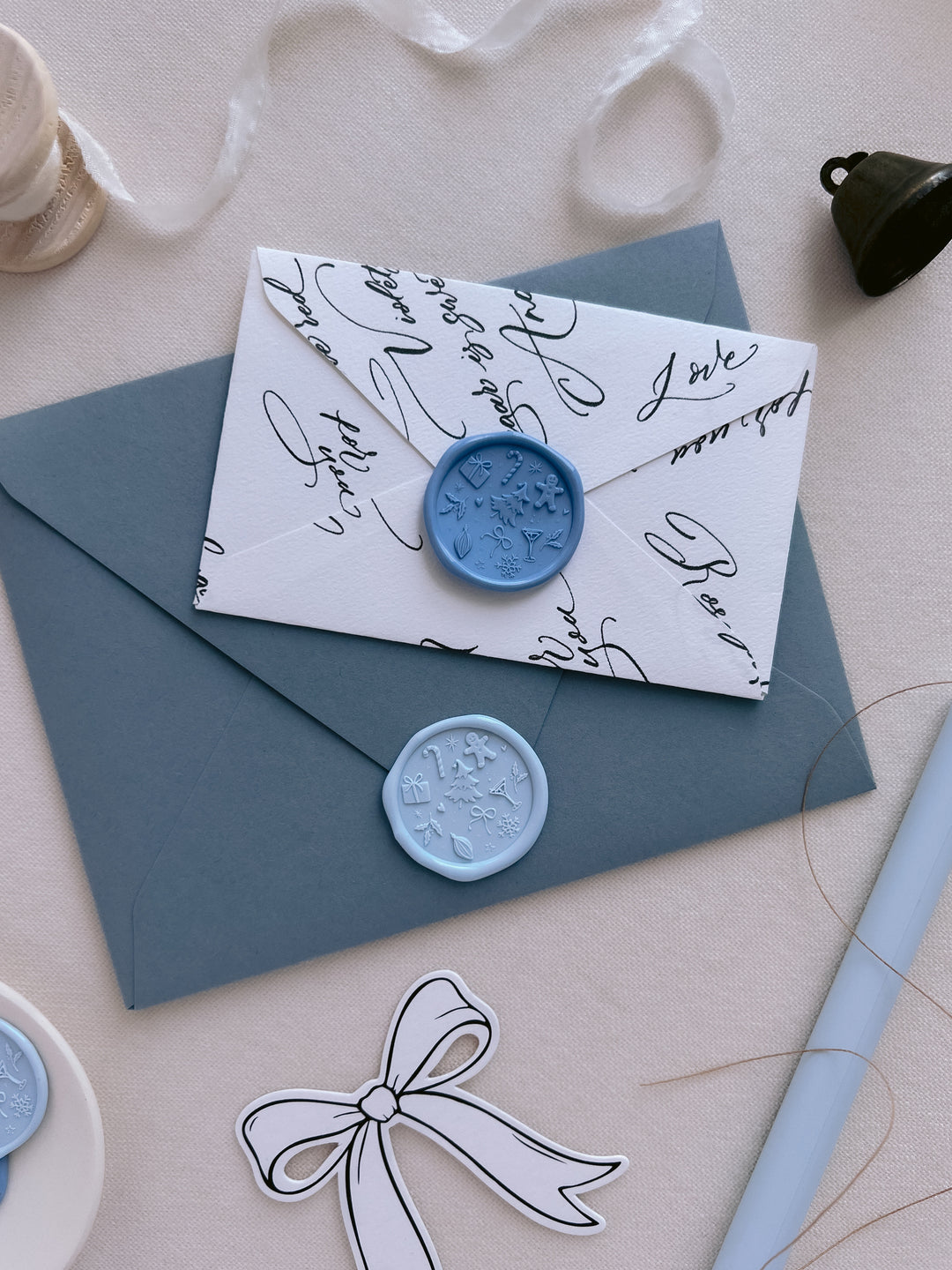 blue and light blue holiday wax seals with festive icons and symbols like Christmas tree, gingerbread man, snowflake, holly and candy cane
