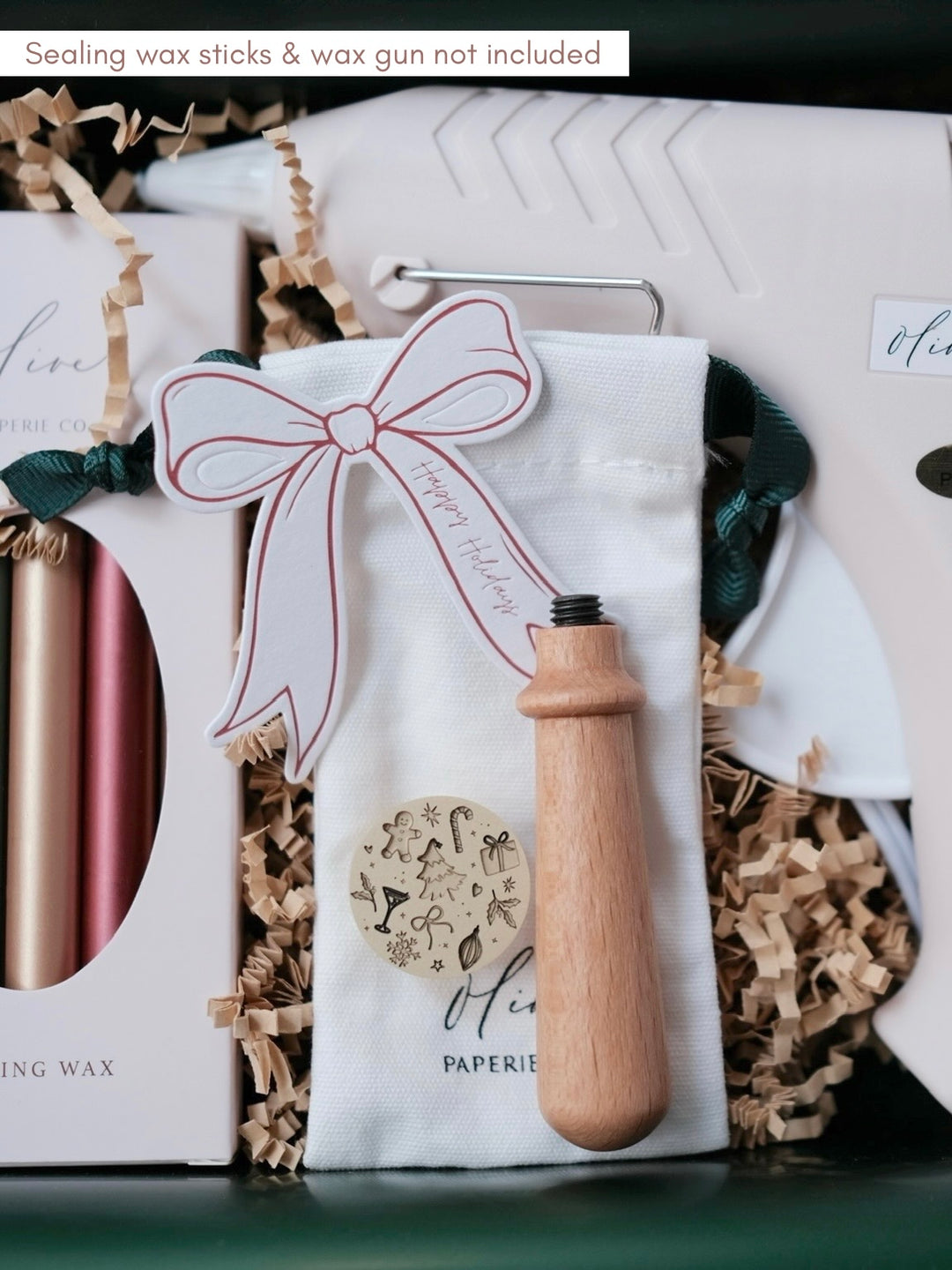 Christmas wax seal kit that includes a festive design wax seal stamp, a wooden wax stamp handle, festive sealing wax sticks and a glue gun