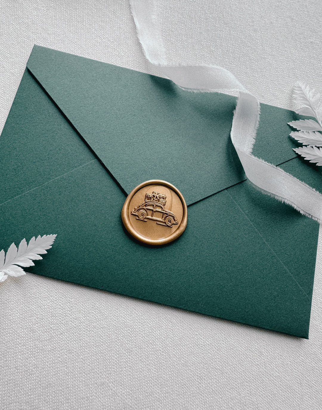 Festive vintage car gold wax seal on a Christmas card envelope