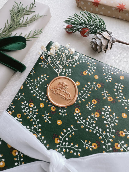 festive car wax seal on Christmas gift wrap