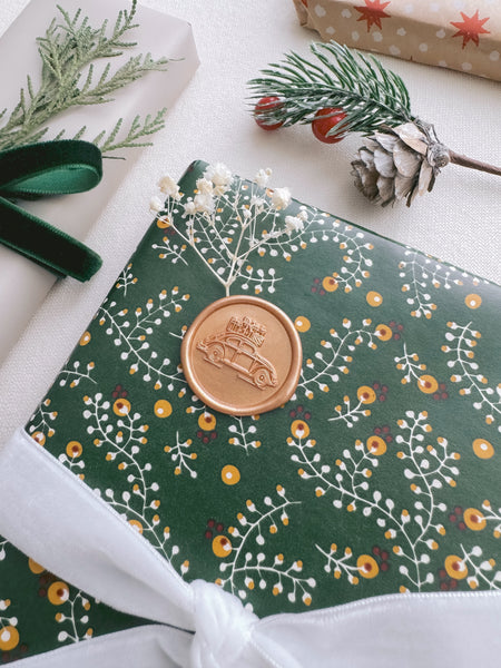 wax seal featuring design of a festive vintage car with Christmas presents 