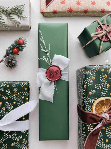 red gift delivery car Christmas wax seal decorated on festive gift wrap