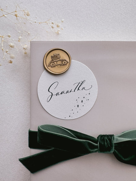 gold Christmas car wax seal on festive personalized gift tag