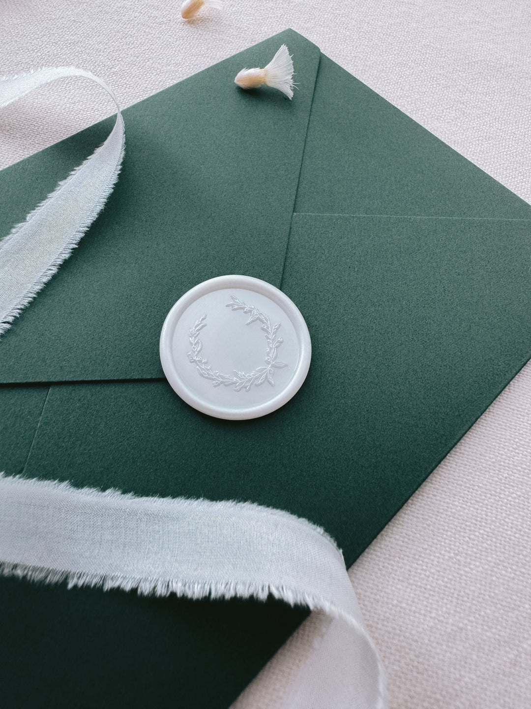 Christmas wreath wax seal on green greeting card envelope