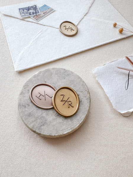 Oval custom monogram wax seals in light bronze and gold