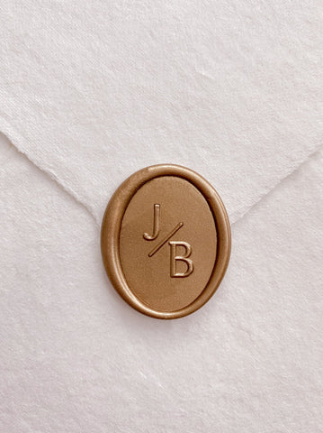 Modern monogram oval gold custom wax seal on beige handmade paper envelope