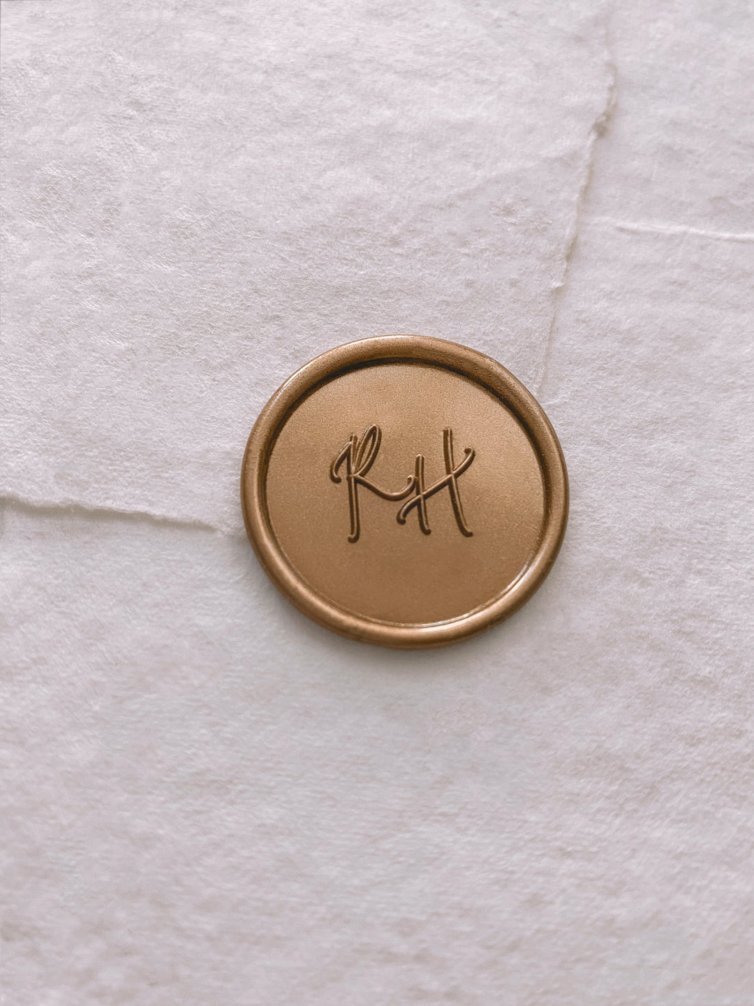 Calligraphy script monogram round gold custom wax seal on white handmade paper envelope